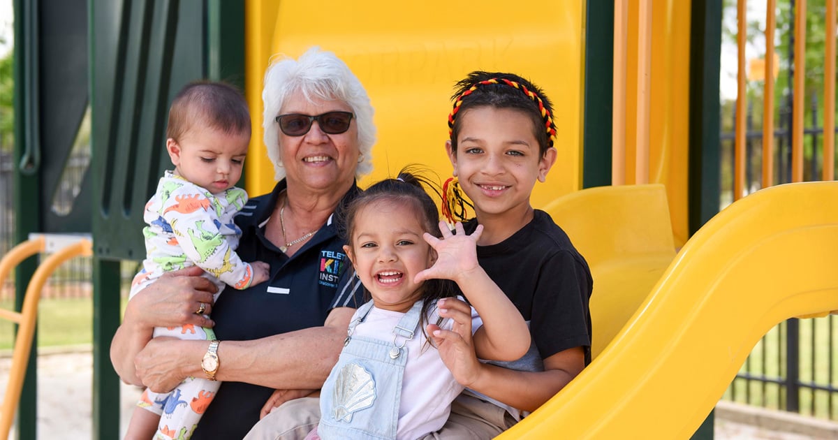 Val Swift with some kids at a playground