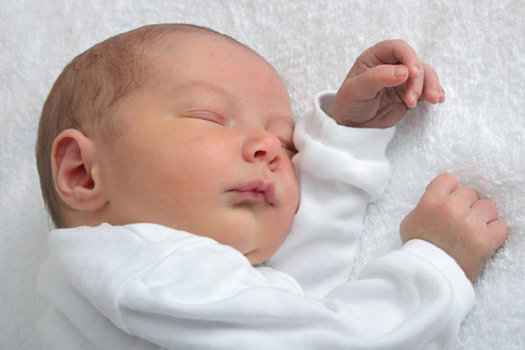 sleeping baby lying on a rug